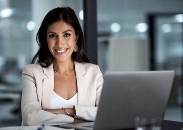 Portrait of a happy businesswoman working at her office desk