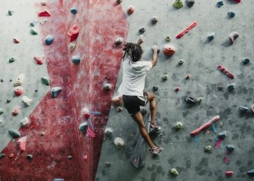 Young man enjoying rock climbing