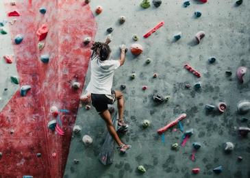 Young man enjoying rock climbing