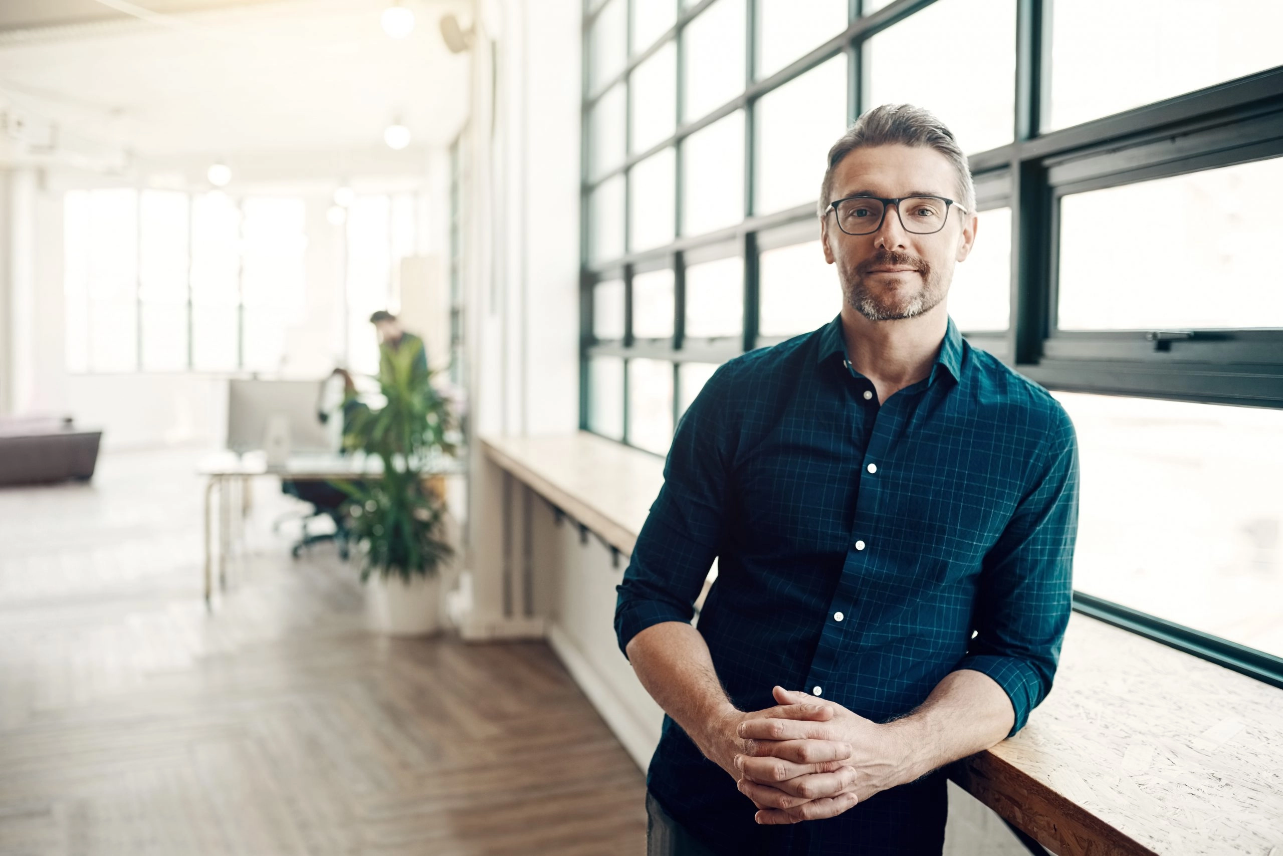 Portrait of a confident mature businessman working in a modern office.