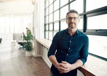 Portrait of a confident mature businessman working in a modern office.